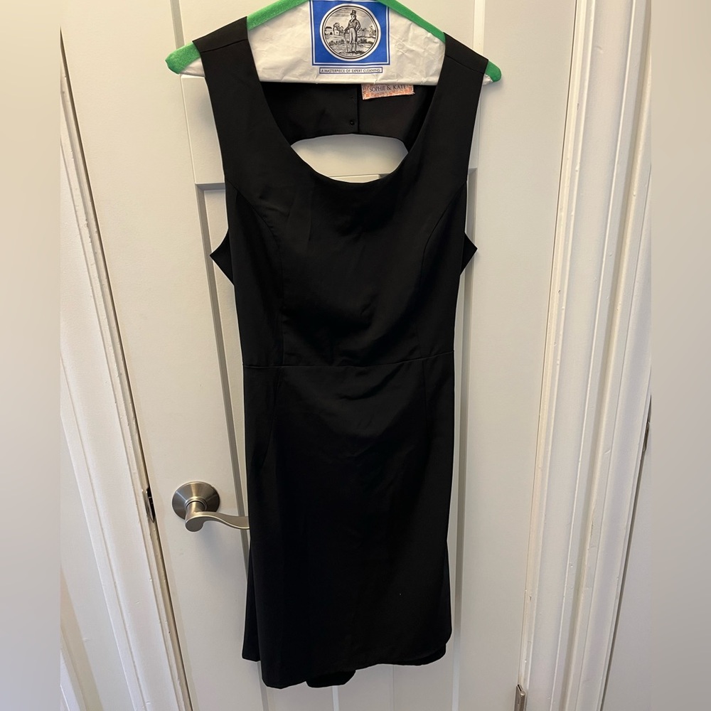 Short black dress with adorable open back detailing.